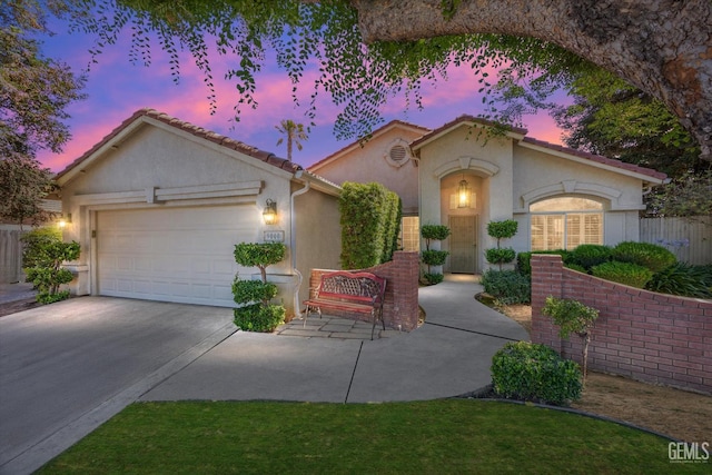 9000 Willamette Ct, Bakersfield, CA 93312 - mediterranean / spanish-style home with stucco siding, driveway, a garage, and a tile roof