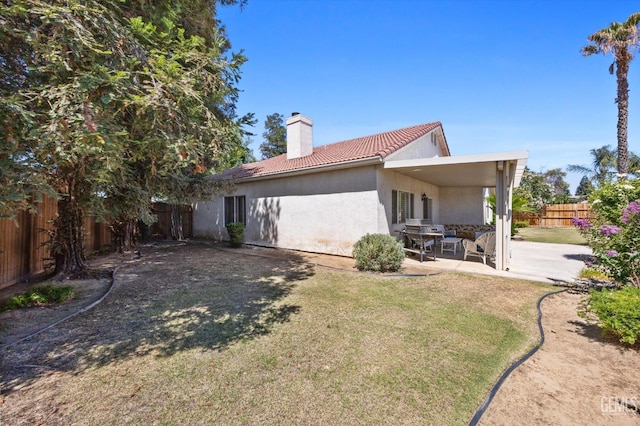 9000 Willamette Ct, Bakersfield, CA 93312 - back of house featuring a chimney, a fenced backyard, a tile roof, stucco siding, and a patio