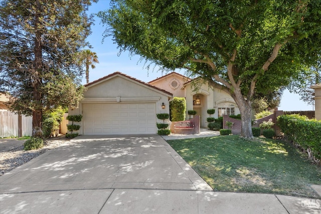 9000 Willamette Ct, Bakersfield, CA 93312 - mediterranean / spanish-style home with an attached garage, stucco siding, driveway, a front lawn, and a tiled roof