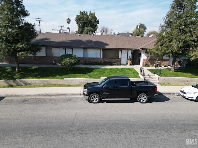 ranch-style house with a front lawn