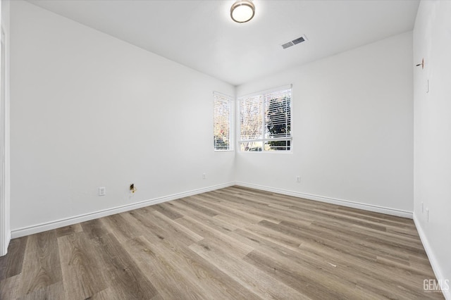 spare room featuring light wood-type flooring