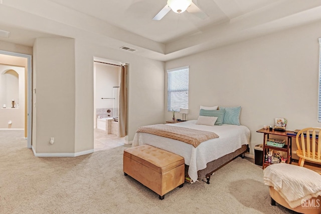 bedroom featuring a ceiling fan, light colored carpet, visible vents, baseboards, and connected bathroom