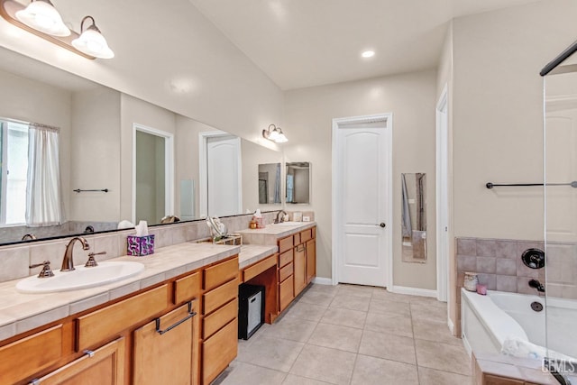 full bathroom with a sink, a bath, tile patterned flooring, and double vanity