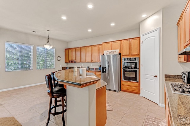 kitchen with a kitchen island with sink, stainless steel appliances, recessed lighting, and light tile patterned floors