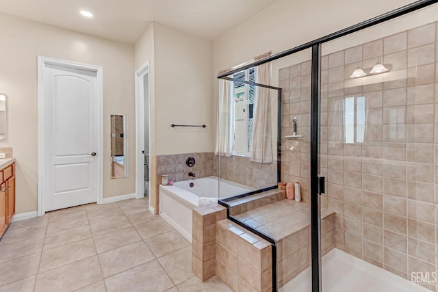 bathroom featuring vanity, tile patterned floors, a stall shower, and a bath
