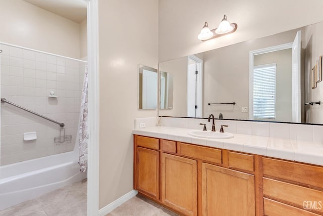 bathroom featuring shower / bath combo with shower curtain, tile patterned flooring, and vanity