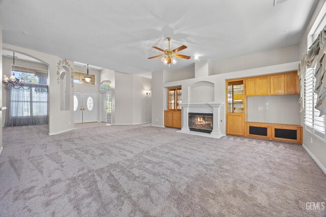 10611 Fishers Peak Dr, Bakersfield, CA 93312 - unfurnished living room with a ceiling fan, carpet flooring, a premium fireplace, and a chandelier