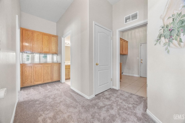 10611 Fishers Peak Dr, Bakersfield, CA 93312 - corridor featuring light carpet and light tile patterned flooring