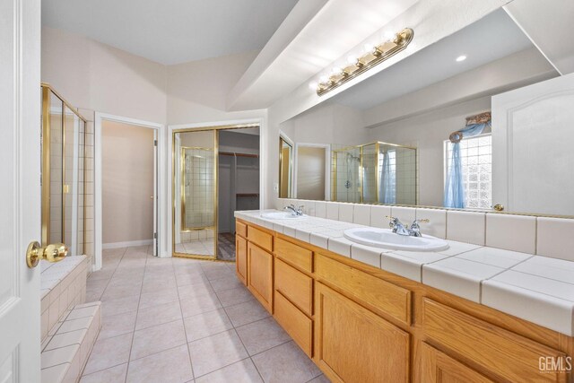 10611 Fishers Peak Dr, Bakersfield, CA 93312 - full bathroom with a shower stall, double vanity, tile patterned floors, and a walk in closet