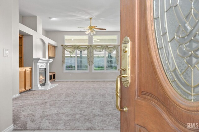 10611 Fishers Peak Dr, Bakersfield, CA 93312 - living area featuring ceiling fan, carpet, and a glass covered fireplace