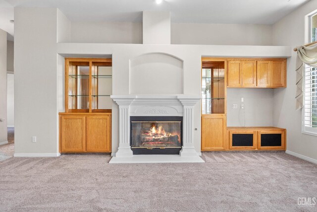 10611 Fishers Peak Dr, Bakersfield, CA 93312 - unfurnished living room featuring carpet floors and a glass covered fireplace