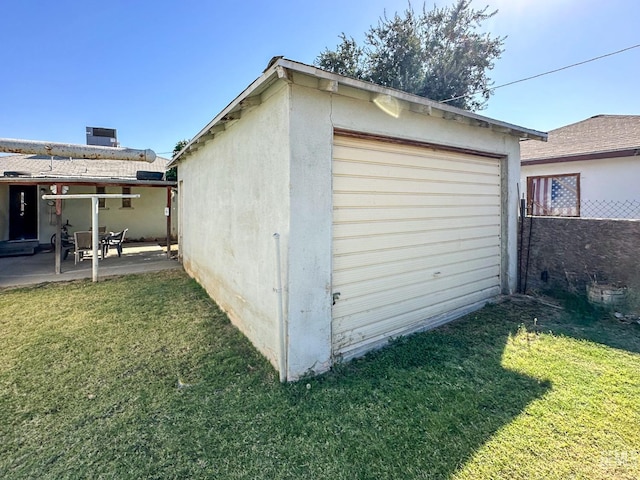 detached garage with fence and driveway