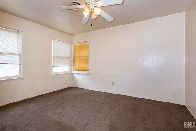 spare room with a ceiling fan and carpet flooring