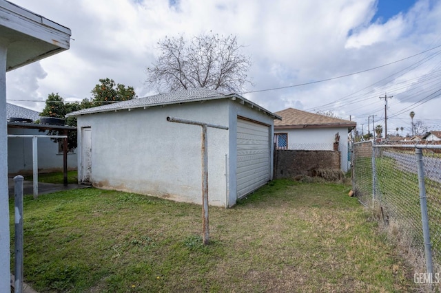 detached garage featuring fence