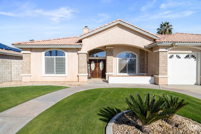 view of front of property featuring a garage and a front lawn