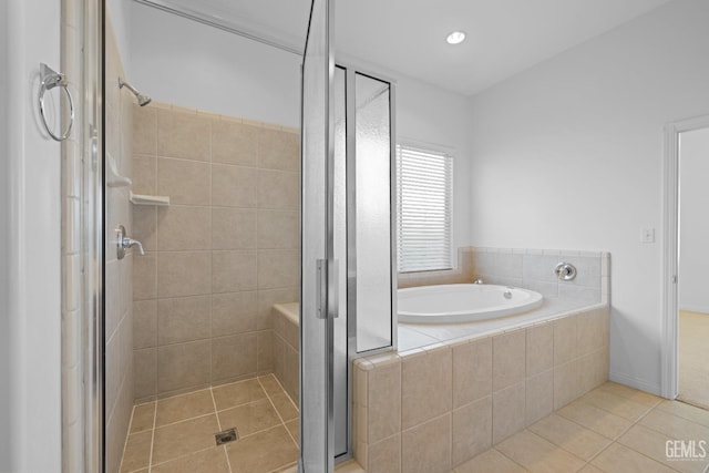 bathroom featuring tile patterned floors and separate shower and tub