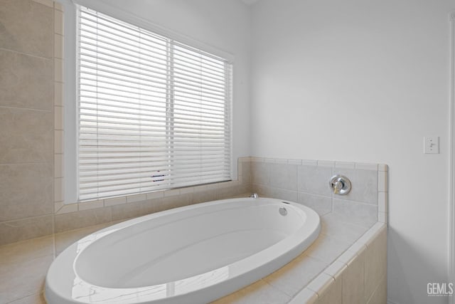 bathroom with a relaxing tiled tub