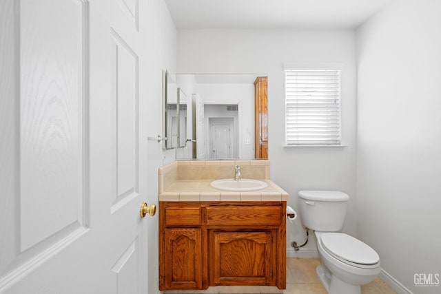 bathroom featuring vanity, tile patterned floors, and toilet