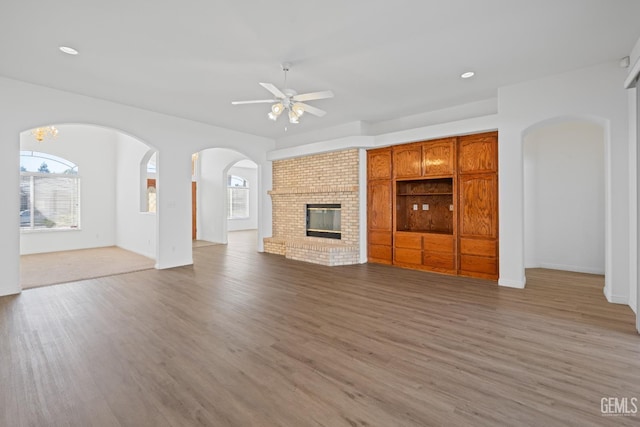 unfurnished living room featuring hardwood / wood-style flooring, a healthy amount of sunlight, and a fireplace