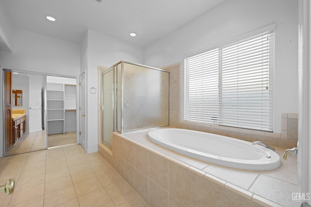 bathroom with vanity, tile patterned floors, and shower with separate bathtub