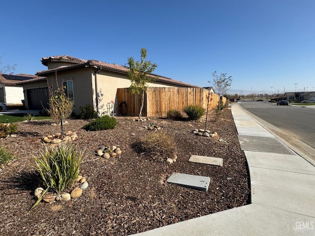 view of side of home featuring a garage