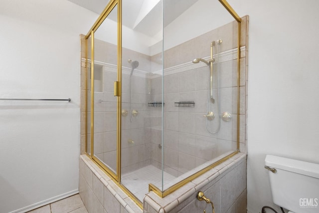 bathroom featuring tile patterned floors, toilet, and walk in shower