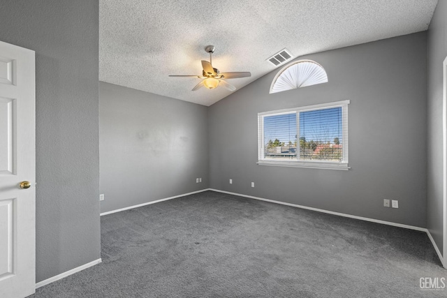 unfurnished room with dark carpet, vaulted ceiling, a textured ceiling, and ceiling fan