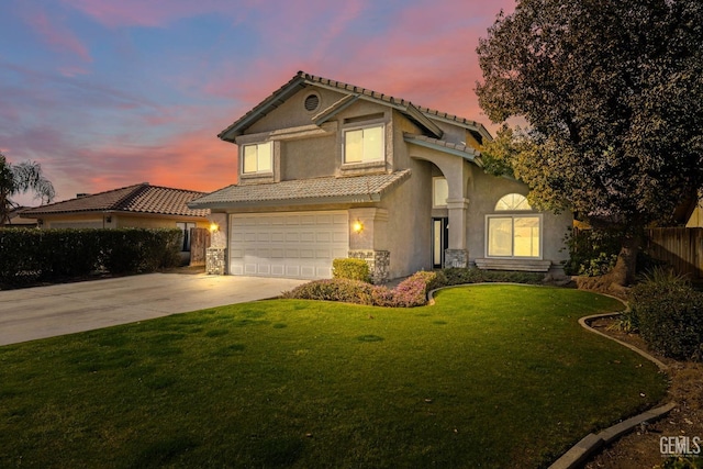 view of front facade with a garage and a lawn