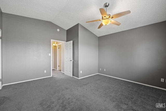 unfurnished bedroom featuring lofted ceiling, ceiling fan, a textured ceiling, and dark colored carpet