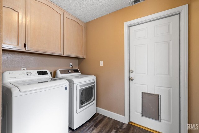 laundry room with cabinets, separate washer and dryer, a textured ceiling, and dark hardwood / wood-style flooring