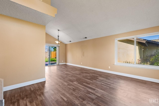 unfurnished living room featuring hardwood / wood-style flooring, lofted ceiling, and a textured ceiling