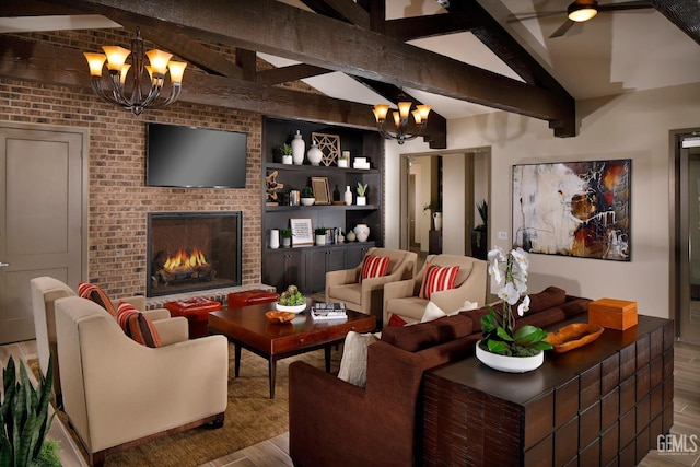 living area with lofted ceiling with beams, ceiling fan with notable chandelier, wood finished floors, and a fireplace