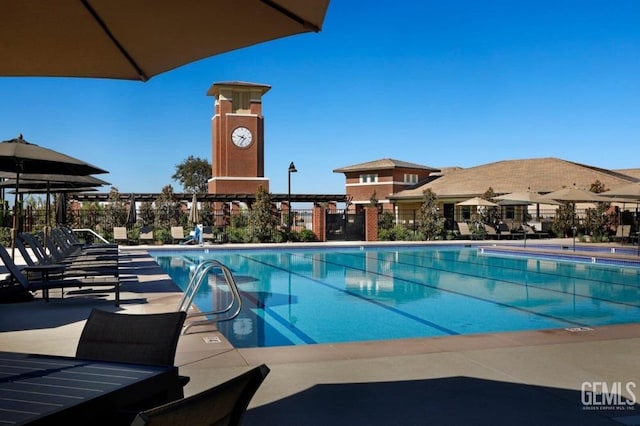pool with fence and a patio