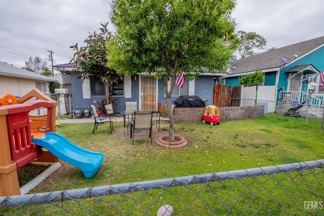 view of jungle gym featuring a lawn