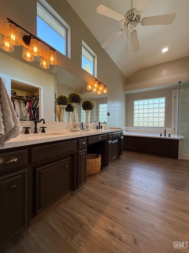15725 Marty Ave, Bakersfield, CA 93314 - full bath featuring wood finished floors, double vanity, a bath, ceiling fan, and a walk in closet