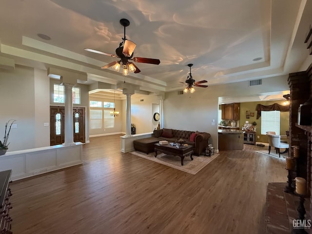 15725 Marty Ave, Bakersfield, CA 93314 - living area featuring decorative columns, a raised ceiling, dark wood-type flooring, and a ceiling fan