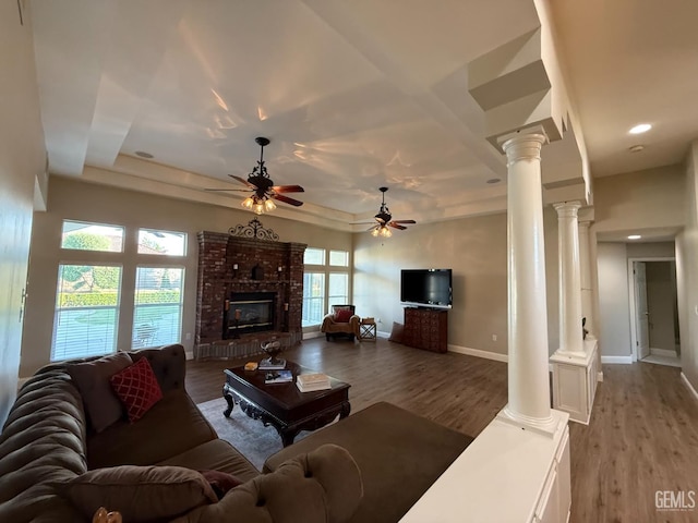 15725 Marty Ave, Bakersfield, CA 93314 - living room featuring decorative columns, ceiling fan, wood finished floors, a brick fireplace, and recessed lighting