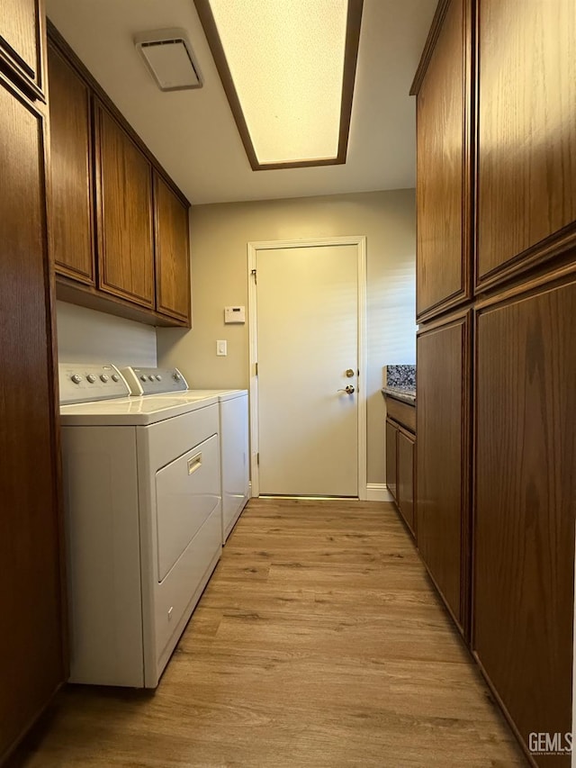 15725 Marty Ave, Bakersfield, CA 93314 - laundry room featuring independent washer and dryer, cabinet space, and light wood finished floors