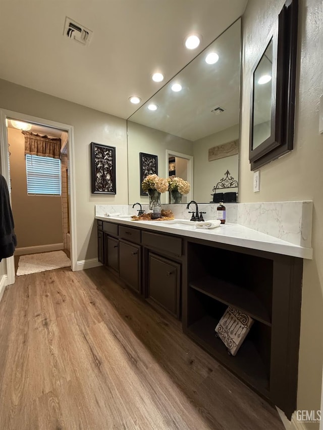 15725 Marty Ave, Bakersfield, CA 93314 - bathroom featuring wood finished floors, double vanity, and recessed lighting