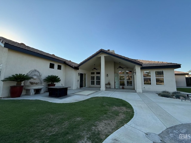 15725 Marty Ave, Bakersfield, CA 93314 - back of property featuring ceiling fan, a patio, a yard, and stucco siding