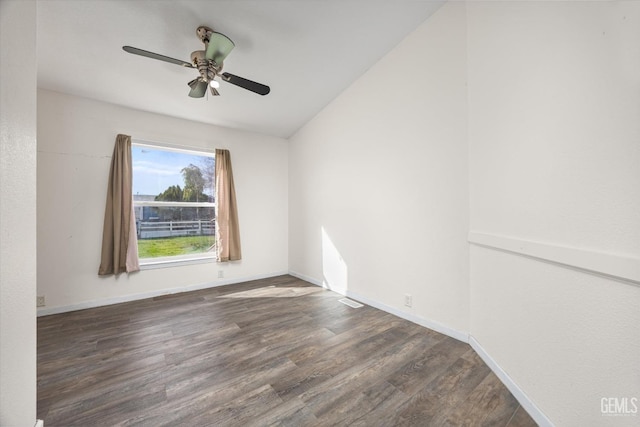 empty room with ceiling fan, wood finished floors, and baseboards