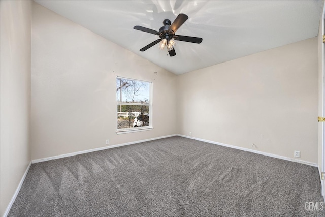 carpeted empty room featuring lofted ceiling, ceiling fan, and baseboards