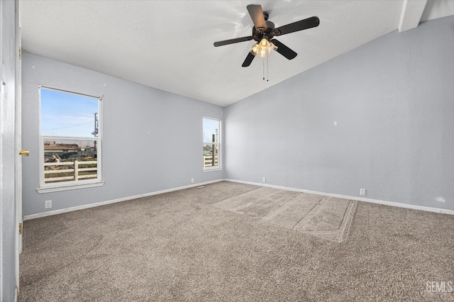 unfurnished room featuring vaulted ceiling, a textured ceiling, carpet flooring, and baseboards