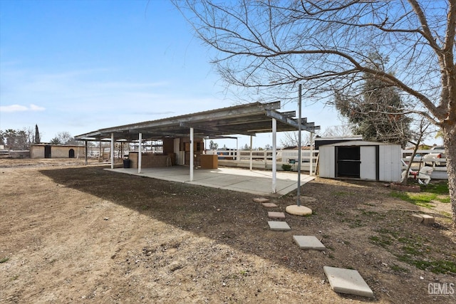 view of vehicle parking featuring a shed