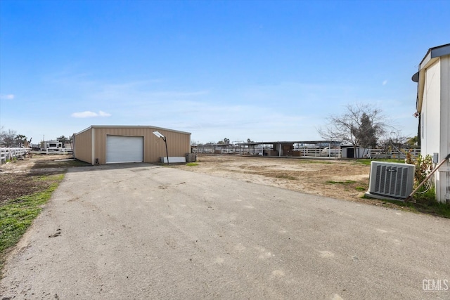 exterior space featuring driveway and central air condition unit