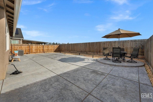 view of patio / terrace with central air condition unit and a fenced backyard