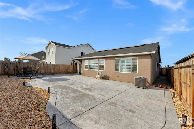 back of house with a patio area, a fenced backyard, and stucco siding