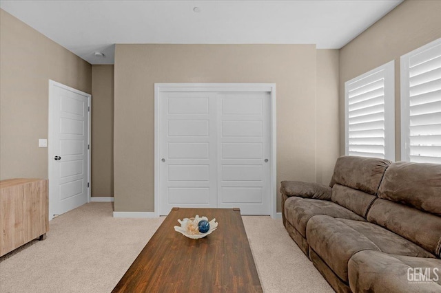 living room with light carpet and baseboards