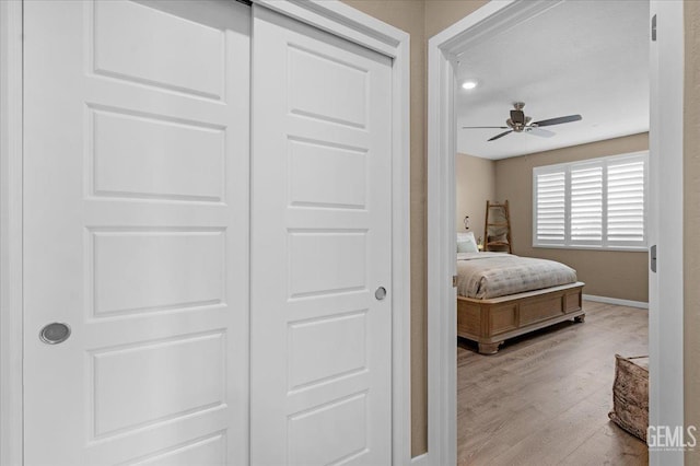 bedroom featuring baseboards and wood finished floors