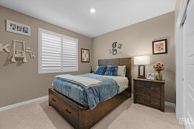 bedroom with baseboards and light carpet